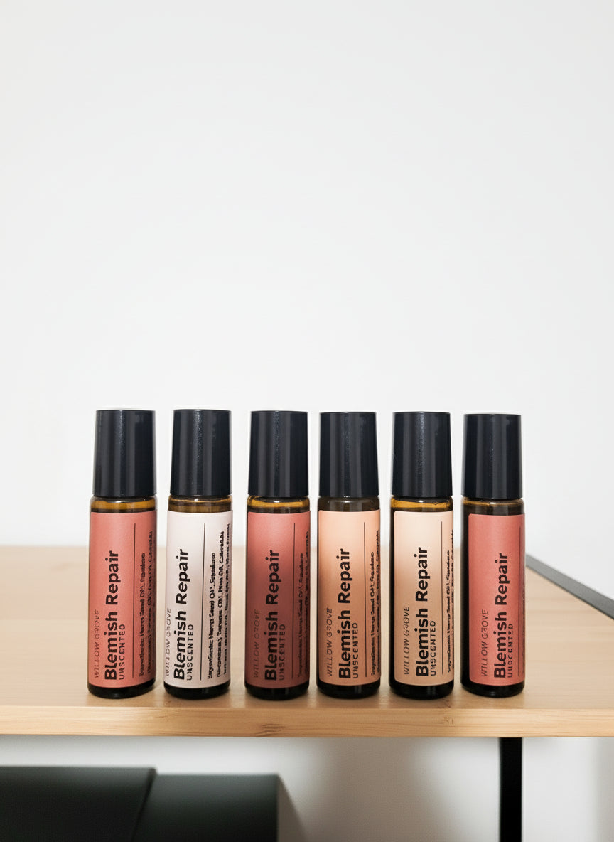 Six bottles of 'Blemish Repair' roller bottles on a wooden surface with a white background